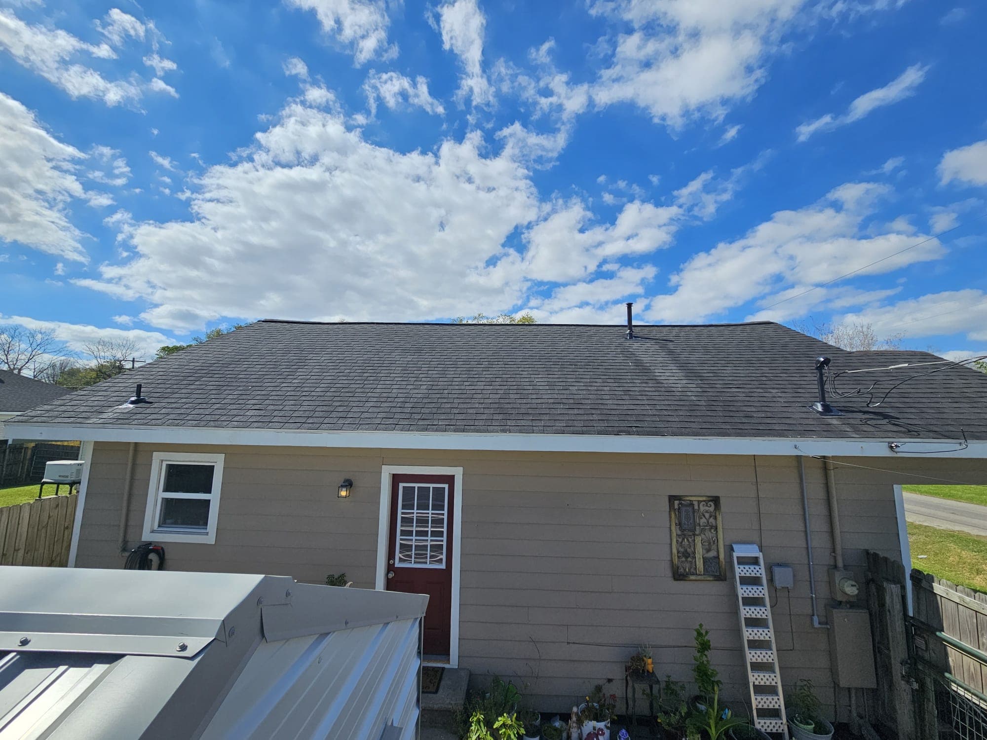 Same roof after Roof Rejoov bio-oil treatment — restored color and flexibility